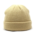 Detailed close-up of khaki ribbed knit texture and wide folded cuff on a warm winter beanie - Beige