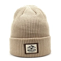 Beige ribbed knit beanie featuring an outdoor bear patch for winter warmth and fashion - Beige