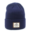 Detail of dark blue ribbed knit beanie featuring an outdoor mountain patch on the fold - Navy Blue