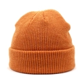 Close-up of bright orange ribbed knit beanie showing high-quality texture and cuffed design - Orange