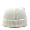 Close-up of white ribbed knit beanie showing thick texture and classic folded cuff - White