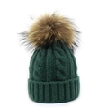 Close-up of deep green cable knit beanie featuring a fluffy brown faux fur pom-pom detail - Adult / Green