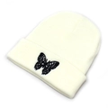 Close-up of fine black butterfly embroidery on off-white knitted beanie with folded edge - M (56-58cm) / White