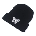 Detailed view of white butterfly embroidery on a black ribbed knit beanie cuff - M (56-58cm) / Black