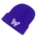 Detail of dark purple knitted beanie featuring a delicate white butterfly embroidery - M (56-58cm) / Purple