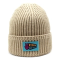 Close-up of khaki ribbed knit beanie with blue embroidered rider car race patch - M(56-58cm) / Khaki