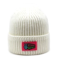 Detail of creamy white ribbed knit beanie featuring a bright pink graphic patch label - M(56-58cm) / White