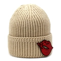 Beige ribbed knit beanie featuring a stylish red sequin lip patch on the folded brim - Khaki