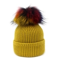 Detail of ginger yellow ribbed knit hat featuring a large multi-color faux fur pompom - One Size / Yellow