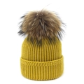Winter knitted beanie in mustard yellow with a fluffy raccoon fur pompom decoration - Yellow / One Size