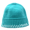Detail of teal knit bucket hat showing ribbed brim and white hand-stitched accents - Blue