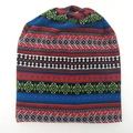 Detail view of ethnic geometric pattern on knitted warm beanie hat for outdoors - Blue