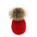 Close-up of red cable knit beanie with large fluffy fur pompom on white background - Lined Adult Style / Red