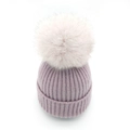Winter knitted beanie in lavender purple with a large fluffy pompom on white background - Purple