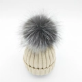 Detail of chunky ribbed knit winter beanie featuring a large fluffy silver fox fur pompom - Adult / Beige