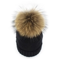 Close-up of black cable knit winter hat with a large fluffy brown faux fur pom-pom - Black