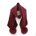 Detailed view of burgundy knit wool scarf featuring large fox fur decorative pompoms - 200cmx25cm / Burgundy