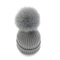 Chic grey ribbed knit beanie for women featuring a large fluffy faux fox fur pom pom - Gray