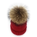 Close-up of a deep red knit beanie featuring a large fluffy brown pom-pom for winter wear - Burgundy