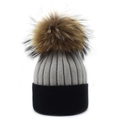 Close-up of two-tone cashmere knit beanie with large fur pompom and ribbed texture - Light Gray and Black