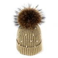 Detail of knitted winter beanie featuring elegant white pearls and a fluffy faux fur pompom - Khaki