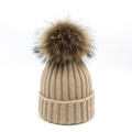 Detailed view of the thick-ribbed knit pattern and large fluffy fur pompom on this beige beanie - M / Beige