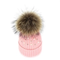 Detail of pink ribbed knit beanie featuring faux pearls and a large fluffy fur pompom - Hot Pink