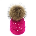 Detail of rose pink knit hat with white pearls, silver studs and large fur pom pom - Rose Red