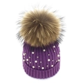 Detail view of purple ribbed knit beanie with white pearls and large faux fur pompom - Purple 1