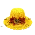 Women's yellow straw sun hat featuring decorative floral accents and a wavy beach brim - Yellow