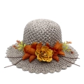 Macro detail of hand-woven straw sun hat featuring elegant fabric peony flower decorations - Gray