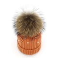 Detail of orange knit beanie with white pearls, silver beads and large fur pompom - Orange