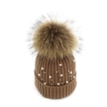 Detailed knit texture of brown beanie with white pearls and a fluffy pom-pom top - Coffee