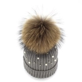 Close-up of grey ribbed knit beanie with white pearls and large fluffy fur pompom - Medium Grey