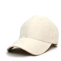 Detailed macro view of beige faux suede baseball cap with visible five-row brim stitching - Beige