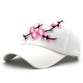 Detailed close-up of pink cherry blossom embroidery on a white cotton baseball cap - Adjustable / White