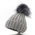 Detailed view of grey thick ribbed knit winter beanie with soft oversized pom-pom - Light Gray