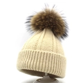 Women's cream knitted beanie with large raccoon fur pompom for autumn and winter warmth - M (56-58cm) / Beige