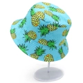 Detail of light blue bucket hat with yellow pineapple print and wide brim for sun protection - Pineapple Print Style / Light Blue