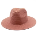 Close-up of coral pink straw sun hat with fine woven texture and classic wide brim - One Size / Dusty Pink