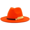 Detailed view of an orange fedora hat featuring a black band and gold feather metal accent - Orange Red