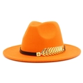 Macro detail of orange wide brim jazz hat with black leather strap and golden leaf charm - Orange