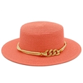 Detailed macro view of coral pink woven boater hat with cream rope and golden chain trim - Pink