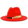 Close-up of red fedora hat featuring a black band and gold feather metal accessory - Red
