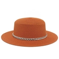 Detailed macro view of vibrant orange straw sun hat with decorative silver metal chain - Caramel color