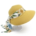 Detail of wide brim straw hat featuring floral ribbon and elegant long-tail bow tie - Khaki