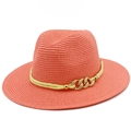 Detail of coral orange woven straw fedora hat featuring a stylish gold chain buckle - Pink