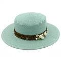 Close-up of mint green straw hat with leopard ribbon, pearls, and flower details - Mint Green