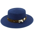Detailed close-up of navy straw hat with leopard print band and pearl floral accents - Dark Blue