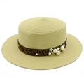 Close-up of woven straw hat with leopard print ribbon and faux pearl embellishments - Beige